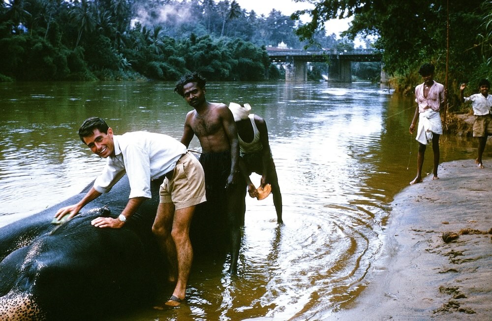 Author's friend Pete on left washing an elephant in a river in Sri Lanka.